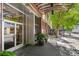 Entrance to commercial location with potted plants and covered sidewalk at 878 Peachtree Ne St # 431, Atlanta, GA 30309