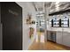 Hallway featuring a pantry door, floating shelves, and an adjacent kitchen area with stainless appliances at 878 Peachtree Ne St # 431, Atlanta, GA 30309