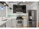 Well-lit kitchen featuring stainless steel appliances, sleek cabinetry, and a mosaic tile backsplash at 878 Peachtree Ne St # 431, Atlanta, GA 30309