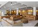 Modern lobby with couches on a patterned rug, wood paneled wall, and unique lighting fixtures at 878 Peachtree Ne St # 431, Atlanta, GA 30309