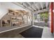 Bright lobby with black rug, gray accent wall, and pictures leading to glass doors and exterior views at 878 Peachtree Ne St # 431, Atlanta, GA 30309