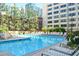 Sparkling outdoor pool with lounge chairs and lush landscaping at 878 Peachtree Ne St # 431, Atlanta, GA 30309