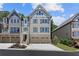 New construction townhome featuring neutral siding, three stories, and a spacious two-car garage at 222 Trecastle Sq # 21, Canton, GA 30114