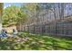 Fenced backyard featuring a grassy area and a small patio perfect for outdoor gatherings at 248 Allegrini Dr, Atlanta, GA 30349