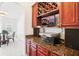 Home bar area with dark wood cabinets, granite countertops, and wine storage at 248 Allegrini Dr, Atlanta, GA 30349