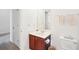 Bathroom features a single vanity with dark wood cabinets, a large mirror, and white walls at 248 Allegrini Dr, Atlanta, GA 30349