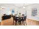 Open concept dining room featuring hardwood floors, a table for six, and natural light at 248 Allegrini Dr, Atlanta, GA 30349