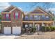 Charming brick home with a covered front porch, two-car garage, red shutters, and manicured landscaping at 248 Allegrini Dr, Atlanta, GA 30349