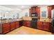 Open concept kitchen features dark wood cabinets, granite countertops, and stainless steel appliances at 248 Allegrini Dr, Atlanta, GA 30349