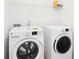 Laundry room featuring a side-by-side washer and dryer setup with overhead storage at 248 Allegrini Dr, Atlanta, GA 30349