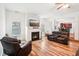 Open concept living room featuring a fireplace and hardwood floors at 248 Allegrini Dr, Atlanta, GA 30349