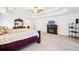 A primary bedroom with a ceiling fan, a bed, a dresser, and a fireplace at 248 Allegrini Dr, Atlanta, GA 30349