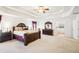 A primary bedroom with a tray ceiling, a bed, and a dresser at 248 Allegrini Dr, Atlanta, GA 30349