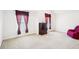 A large, open sitting room featuring a dresser, two windows, and a love seat at 248 Allegrini Dr, Atlanta, GA 30349