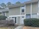 Charming townhouse with a well-kept lawn and cozy entrance, featuring a two-story facade and white trim at 654 Powers Ferry North Se, Marietta, GA 30067