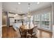 Bright breakfast nook featuring hardwood floors, a kitchen island and lots of windows at 12015 Wildwood Springs Dr, Roswell, GA 30075