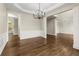 Elegant dining room with modern chandelier, wainscoting detail, and hardwood floors at 608 Chickory Ct, Woodstock, GA 30188