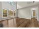 Spacious living room boasting soaring windows, wood flooring, and seamless access to the bathroom at 608 Chickory Ct, Woodstock, GA 30188