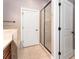 Bathroom featuring a glass shower door, tile flooring, and modern fixtures at 2447 Gatebury Cir, Chamblee, GA 30341