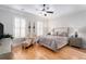 Bright bedroom featuring hardwood floors, a ceiling fan, and two windows at 2447 Gatebury Cir, Chamblee, GA 30341