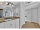 Inviting bathroom showcases a granite countertop, dual mirrors, elegant lighting, and convenient storage options at 2621 Trailing Ivy Way, Buford, GA 30519