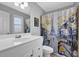 Bright bathroom with a shower/tub combo and a modern vanity with ample storage at 2621 Trailing Ivy Way, Buford, GA 30519