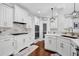 Bright kitchen features white cabinetry, marble countertops, stainless steel appliances, and a charming pantry door at 2621 Trailing Ivy Way, Buford, GA 30519