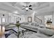 Expansive living room with hardwood floors, coffered ceiling, and an open layout to adjacent rooms at 2621 Trailing Ivy Way, Buford, GA 30519