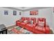 Cozy theater room with red leather recliners, movie-themed decor, and a fun patterned rug at 2621 Trailing Ivy Way, Buford, GA 30519