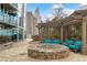 Comfortable outdoor lounge with a stone fire pit, cozy seating, and a stylish pergola for relaxation at 3324 Peachtree Ne Rd # 1510, Atlanta, GA 30326