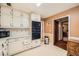 Kitchen boasting ample cabinet space and an open layout leading to a warm-toned room at 4605 Tims Pl, Snellville, GA 30039