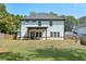 Exterior back of home with a covered patio and fenced yard at 58 Cherry St, Lawrenceville, GA 30046