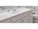 A bathroom with white cabinets, a white sink, and a bathtub is shown at 58 Cherry St, Lawrenceville, GA 30046