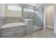 This bathroom features a bathtub and glass-enclosed shower with gray tile at 58 Cherry St, Lawrenceville, GA 30046