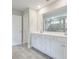 This bathroom features a double vanity, bathtub and glass-enclosed shower at 58 Cherry St, Lawrenceville, GA 30046
