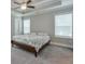 Primary bedroom with tray ceiling, ceiling fan and neutral carpeting. Lots of natural light at 58 Cherry St, Lawrenceville, GA 30046