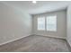 This bedroom features neutral walls, carpet floors and a large window at 58 Cherry St, Lawrenceville, GA 30046