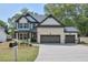 Beautiful two-story home featuring brick and white siding, a three-car garage and a well-manicured lawn at 58 Cherry St, Lawrenceville, GA 30046