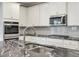 Gourmet kitchen with sleek granite countertops, stainless steel appliances and stylish backsplash at 58 Cherry St, Lawrenceville, GA 30046