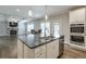 Well-lit kitchen area with stainless steel appliances, breakfast nook and view to the living area at 58 Cherry St, Lawrenceville, GA 30046