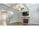 Inviting living room with coffered ceiling, stone fireplace, hardwood floors, and staircase access at 58 Cherry St, Lawrenceville, GA 30046