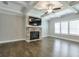 Cozy living room with a stone fireplace, coffered ceilings, hardwood floors and natural light at 58 Cherry St, Lawrenceville, GA 30046