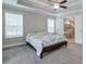 This main bedroom features a fan, tray ceilings and an en suite bathroom at 58 Cherry St, Lawrenceville, GA 30046