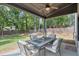 Covered patio with ceiling fan and outdoor seating overlooking the backyard at 58 Cherry St, Lawrenceville, GA 30046