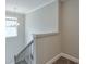 Stairwell with carpet runner and iron railing. Natural light at 58 Cherry St, Lawrenceville, GA 30046