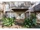 A backyard patio underneath a wooden deck, surrounded by lush plants at 104 Terrace Dr # 6, Atlanta, GA 30305