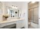 Bright bathroom featuring a vanity with ample counter space, decorative mirror, and a glass-enclosed shower at 104 Terrace Dr # 6, Atlanta, GA 30305