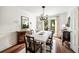 Bright dining room with modern light fixture, white table, dark wood accents, and access to an outdoor deck at 104 Terrace Dr # 6, Atlanta, GA 30305