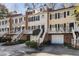 Townhome exterior boasting colorful façades, black shutters, and well-manicured landscaping at 104 Terrace Dr # 6, Atlanta, GA 30305