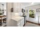 Compact kitchenette featuring white cabinets, tiled backsplash, and stainless steel appliances, seamlessly connecting to the dining area at 104 Terrace Dr # 6, Atlanta, GA 30305